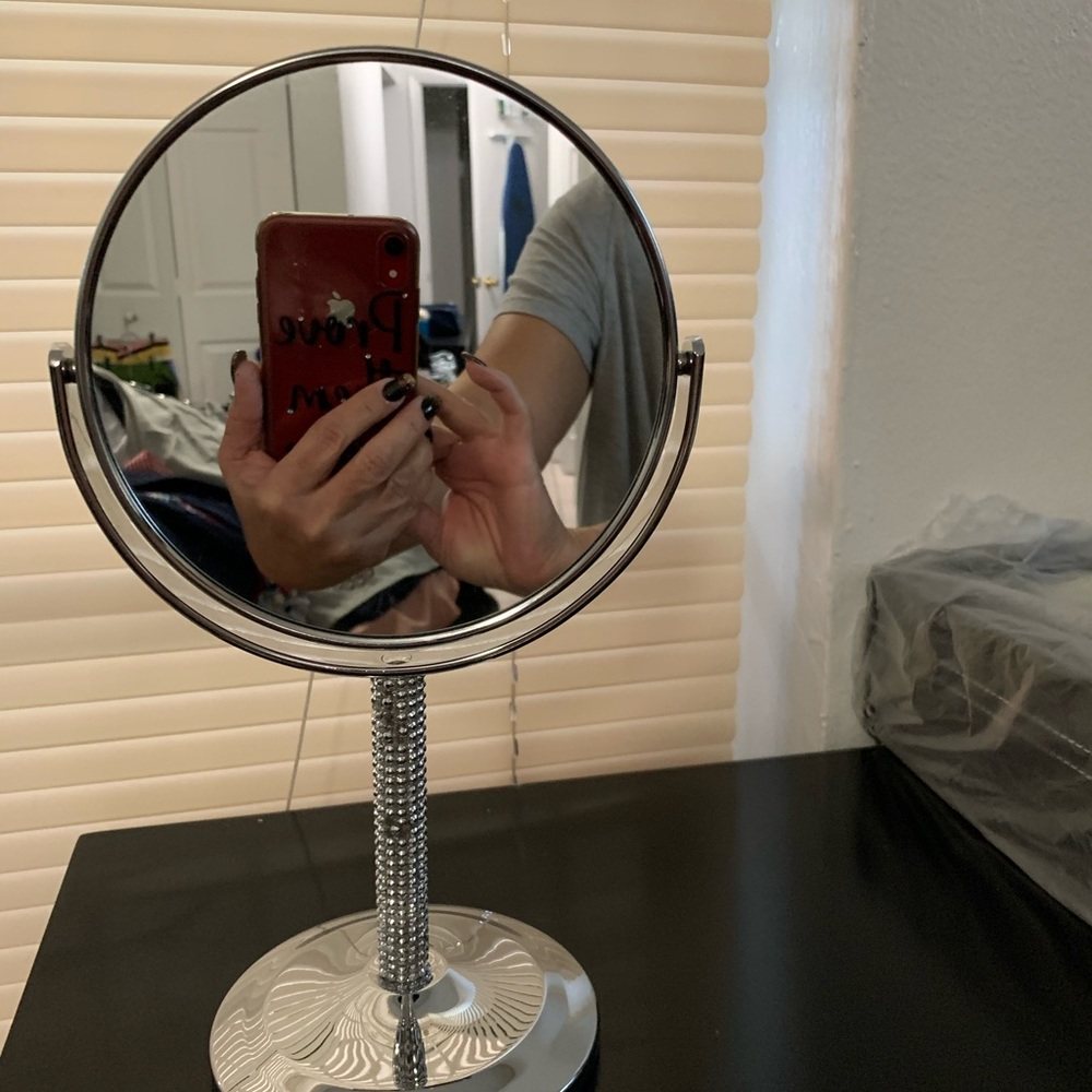 Rhinestone makeup mirror with magnifying side.